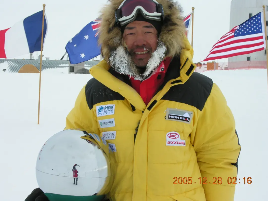 张梁身穿黄色极地服,站在冰雪覆盖的旷野中